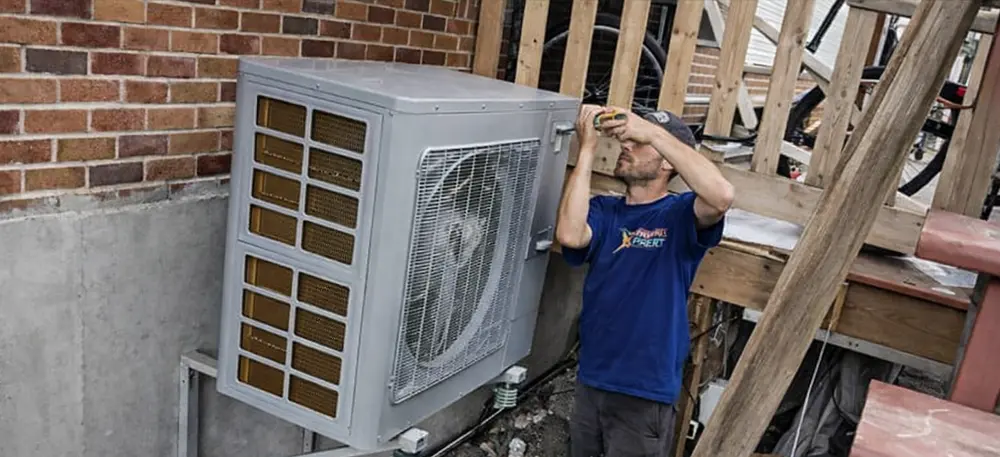 HVAC technician repairing an outdoor unit
